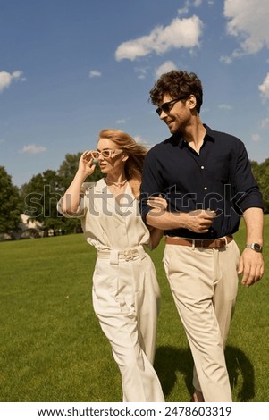 Similar – Image, Stock Photo A fashionable couple, dressed in white and wearing avant-garde shoes, is having some fun in the green meadow. With a cow. It’s a great outdoor wanderlust at its best. On a wild summer night.