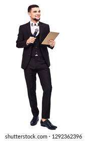 Stylish Elegant Man In A Black Suit With A Microphone And A Tablet In His Hands. Isolated On White