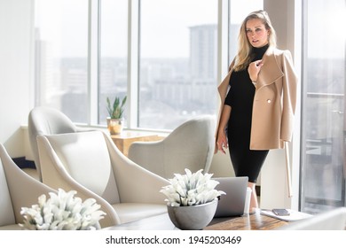 Stylish And Elegant, Sophisticated Fashionable Businesswoman In Classy Business Executive Outfit, Posing In Luxurious Workspace Lobby With City Skyline Backdrop View Of Buildings