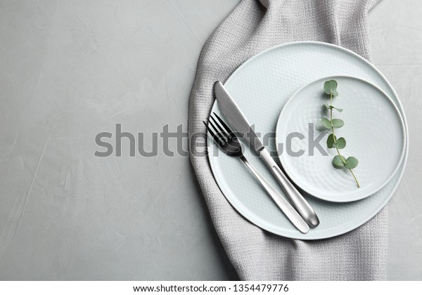 Stylish elegant table setting on light background,\
top view. Space for\
text