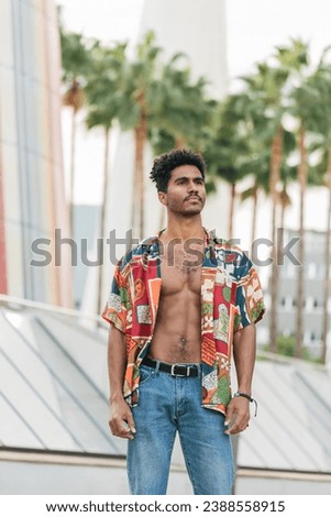 Stylish ethnic man wearing colorful unbuttoned shirt [[stock_photo]] © 