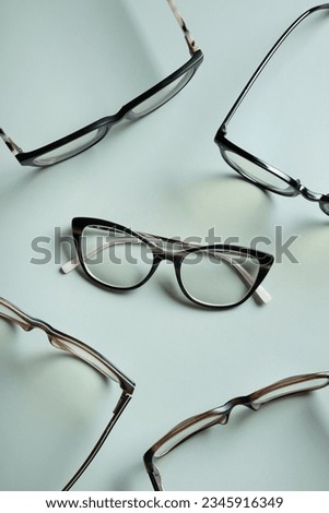 Stylish eyeglasses on colored background. Optical store, vision test, stylish glasses concept