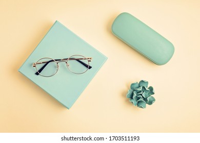 Stylish eyeglasses over pastel  background. Optical store, glasses selection, eye test, vision examination at optician, fashion accessories concept. Top view, flat lay - Powered by Shutterstock