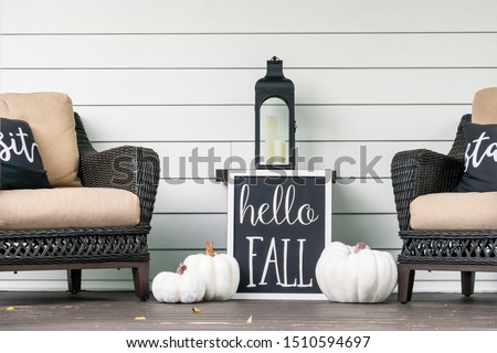 Stylish fall decorations in black and white on the front porch - hello fall