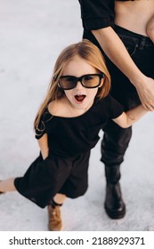 stylish family photo shoot for young parents and their daughters on a black fabric photo set in nature - Shutterstock ID 2188929371