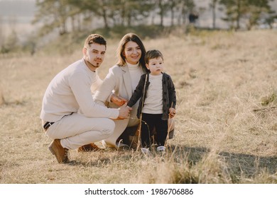 Stylish Family Walking On A Spring Field