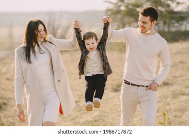 Stylish Family Walking On A Spring Field