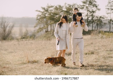 Stylish Family Walking On A Spring Field