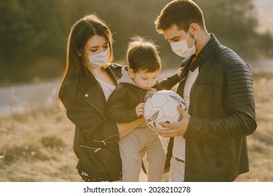 Stylish Family Walking On A Spring Field