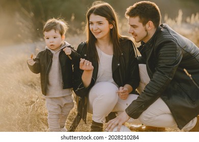 Stylish Family Walking On A Spring Field