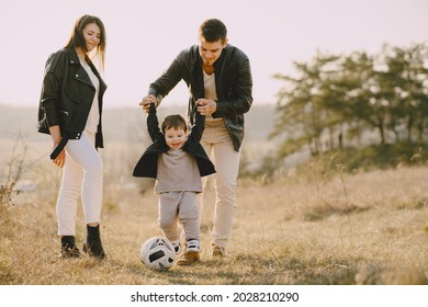 Stylish Family Walking On A Spring Field