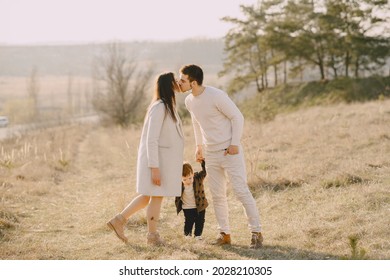 Stylish Family Walking On A Spring Field