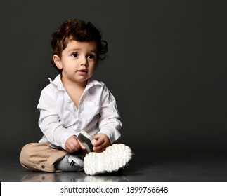 Stylish fashionable kid. Model baby toddler in casual clothes. Isolated portrait isolated shot on gray studio background. Fashion and Style. Trendy outfit for children's advertising