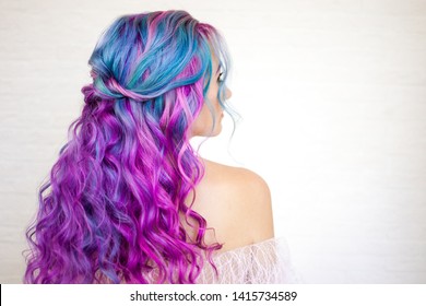 Stylish fashionable young woman and bright hair coloring  Magenta   purple  Beautiful curls  stylish styling