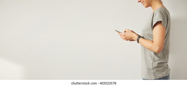 Stylish Female Checking Email Via Cell Phone While Standing Against White Background With Copy Space For Your Text Message Or Promotional Content 