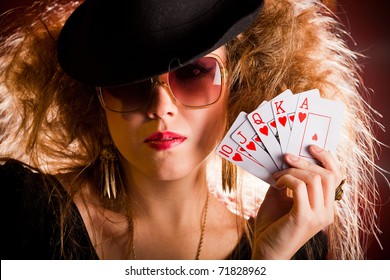 Stylish Female Poker Player Holding A Royal Flush