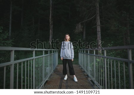 Similar – ein Mädchen mit langen Haaren und blauen Augen in den Bergen, das mit einer Kapuze lächelt