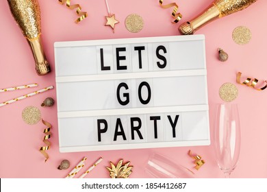 Stylish Festive Party Decor In Golden Color On Pink Background And Lightbox With Text Let's Go Party. Flay Lay