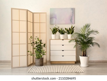 Stylish folding screen near wall in room interior - Shutterstock ID 2110284695