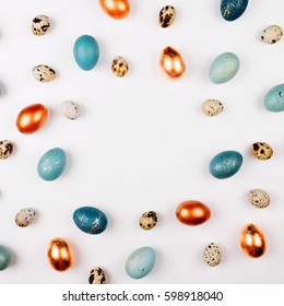 Stylish Frame Background With Quail, Gold And Blue Easter Eggs With Copy Space For Text. Isolated On White Background. Flat Lay, Top View. Easter Concept.