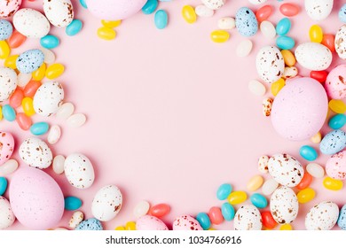 Stylish Frame Made Of Easter Candy Chocolate Eggs And Jellybean On Pink Background