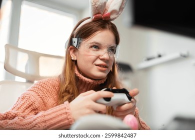 Stylish gaming setup with Easter spirit. Cozy room with pastel decorations, LED glasses, and happy gamer in bunny ears playing with controller, enjoying festive vibes.
