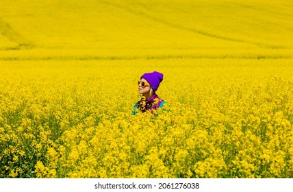 Stylish Girl In 90s Tracksuit In Rapeseed Field 