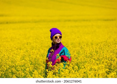 Stylish Girl In 90s Tracksuit In Rapeseed Field 