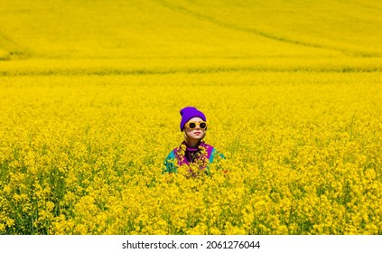 Stylish Girl In 90s Tracksuit In Rapeseed Field 