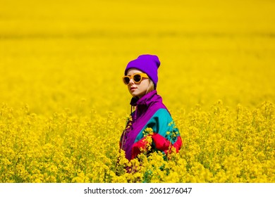 Stylish Girl In 90s Tracksuit In Rapeseed Field 