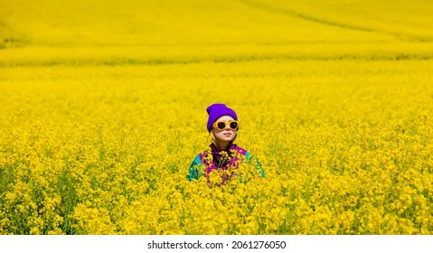 Stylish Girl In 90s Tracksuit In Rapeseed Field 