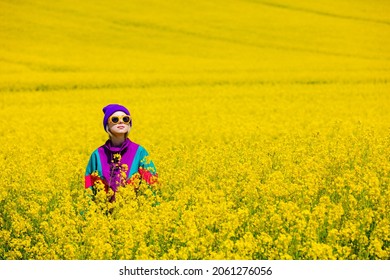 Stylish Girl In 90s Tracksuit In Rapeseed Field 