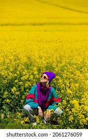 Stylish Girl In 90s Tracksuit In Rapeseed Field 