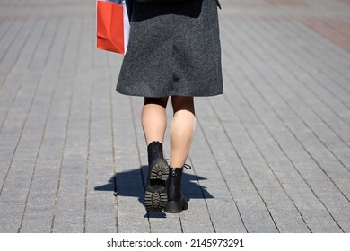 Stylish Girl In Coat Walking On A Street, Rear View. Female Legs In Flesh-colored Stockings And Shoes, Fashion In Spring City