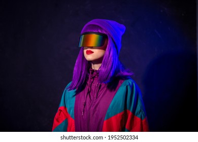 Stylish Girl In Cyber Punk Glasses And 80s Tracksuit On Dark Background