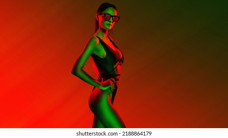 Stylish Girl Portrait Near Pink Green Neon Light Sign. Portrait In Cool Neon Light.