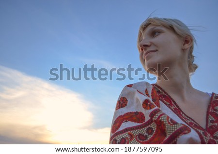 Similar – Young pretty woman in a pink blazer stands in front of an orange wall