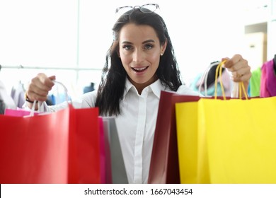 Stylish Girl Shows Off Packages With Purchases. Pick Up All Things So That They Fit Well Together And Form Convenient Sets. Personal Shopping Consultant Service. Corporate Dress Code.