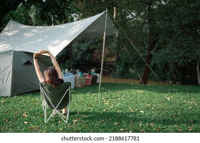 stylish girl Sit with your back on the lawn chair. rest on vacation Female tourists like to go camping. pitch a tent and sleep in the natural forest - Shutterstock ID 2188617781