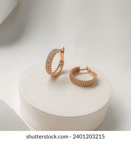 Stylish gold earrings with English lock and cubic zirconia.