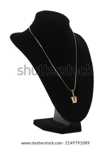 Stylish golden necklace on jewelry bust against white background