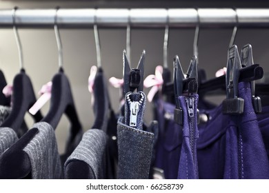 Stylish Gray And Violet Women's Clothes On Black Velvet Hangers In Luxury Shop, Zipper On A Jean's Skirt Accented