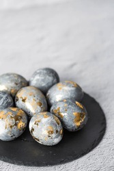 Stylish Grey Easter Eggs Made Of Marble And Concrete With A Golden Potala On A Grey Background. Coloring Eggs With Natural Dye Karkade Tea. The Concept Of A Happy Easter.