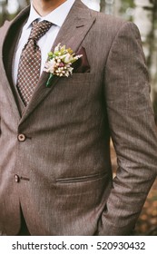 Stylish Groom And The Details Of His Outfit: The Buttonhole And A Tie
