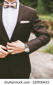 Stylish Groom And The Details Of His Outfit: The Buttonhole And A Bow Tie