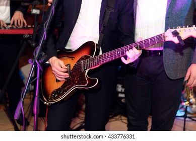 Stylish Guitarist Singer Playing On A Stage With A Band On Wedding Reception