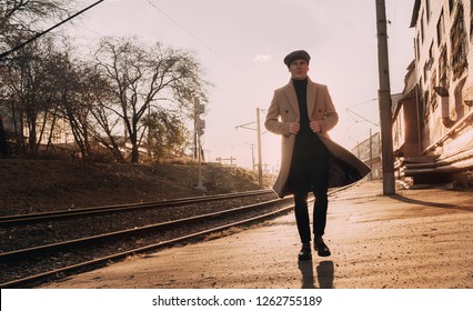 stylish guy in a coat and cap posing on the street - Shutterstock ID 1262755189