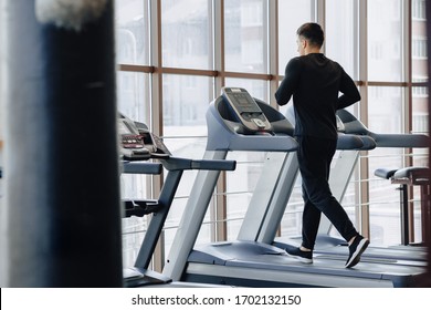 Stylish Guy In The Gym Is Training On The Treadmill. Healthy Lifestyle. Wellness.