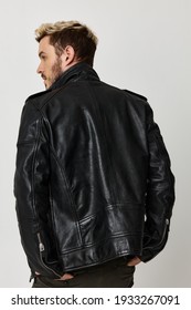 Stylish Guy In A Leather Jacket Looks To The Side Back View