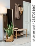 Stylish hallway interior with coat rack and mirror